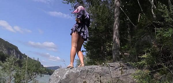  Under the skirt without panties. Voyeur peeks under the dress outdoors and admires hairy pussy and juicy PAWG. Amateur fetish.